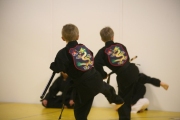 Junior-black-belts-in-sync-with-bo-staff-form